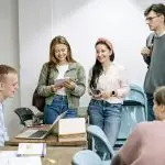 A diverse group of college students engaging in a lively study session indoors.