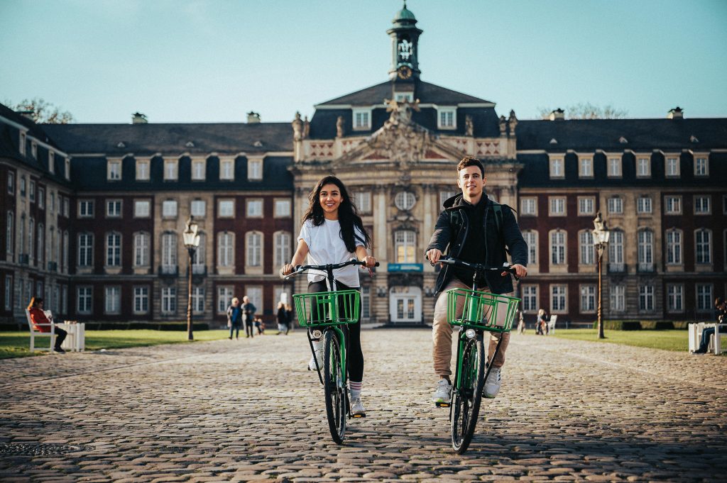 A couple rides bicycles after using german dating sites in germany