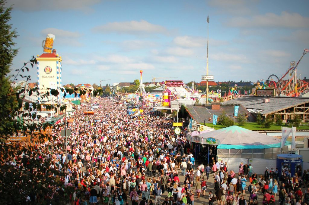 The picture shows the largest German beer festival -- Oktoberfest in Munich with a massive crowd enjoying the festivities and attractions.