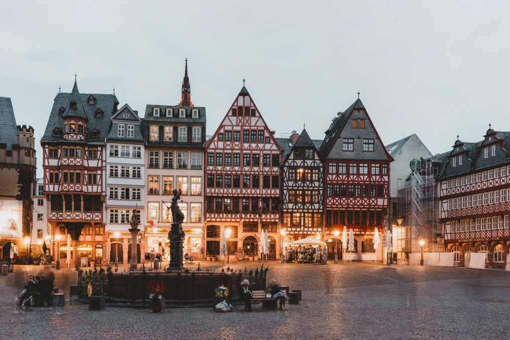 Quaint Römer Square in Frankfurt showcasing traditional half-timbered houses at dusk.