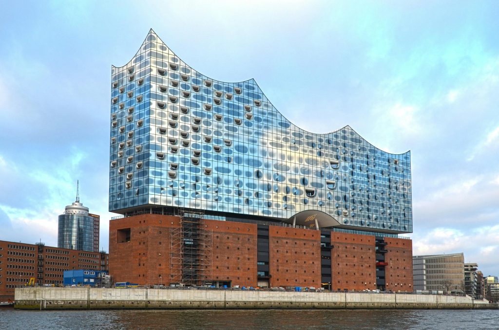 Stunning view of the Elbphilharmonie concert hall reflecting the sky on the Elbe River.