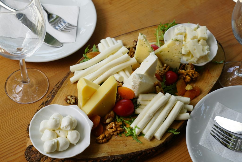 Different kinds cheeses with nuts, fruit in the traditional German breakfast.